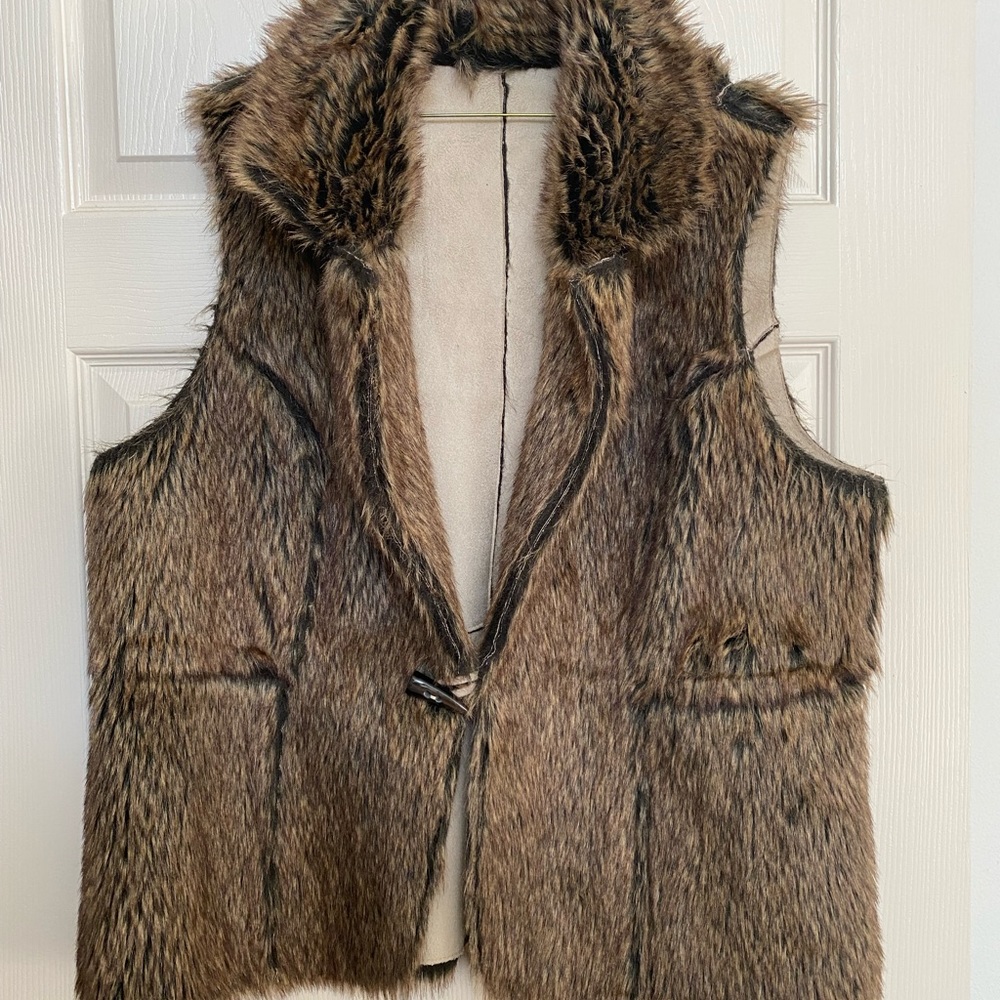 Reversible vest.  One side is Suede.  Brown/Black/Off White in color